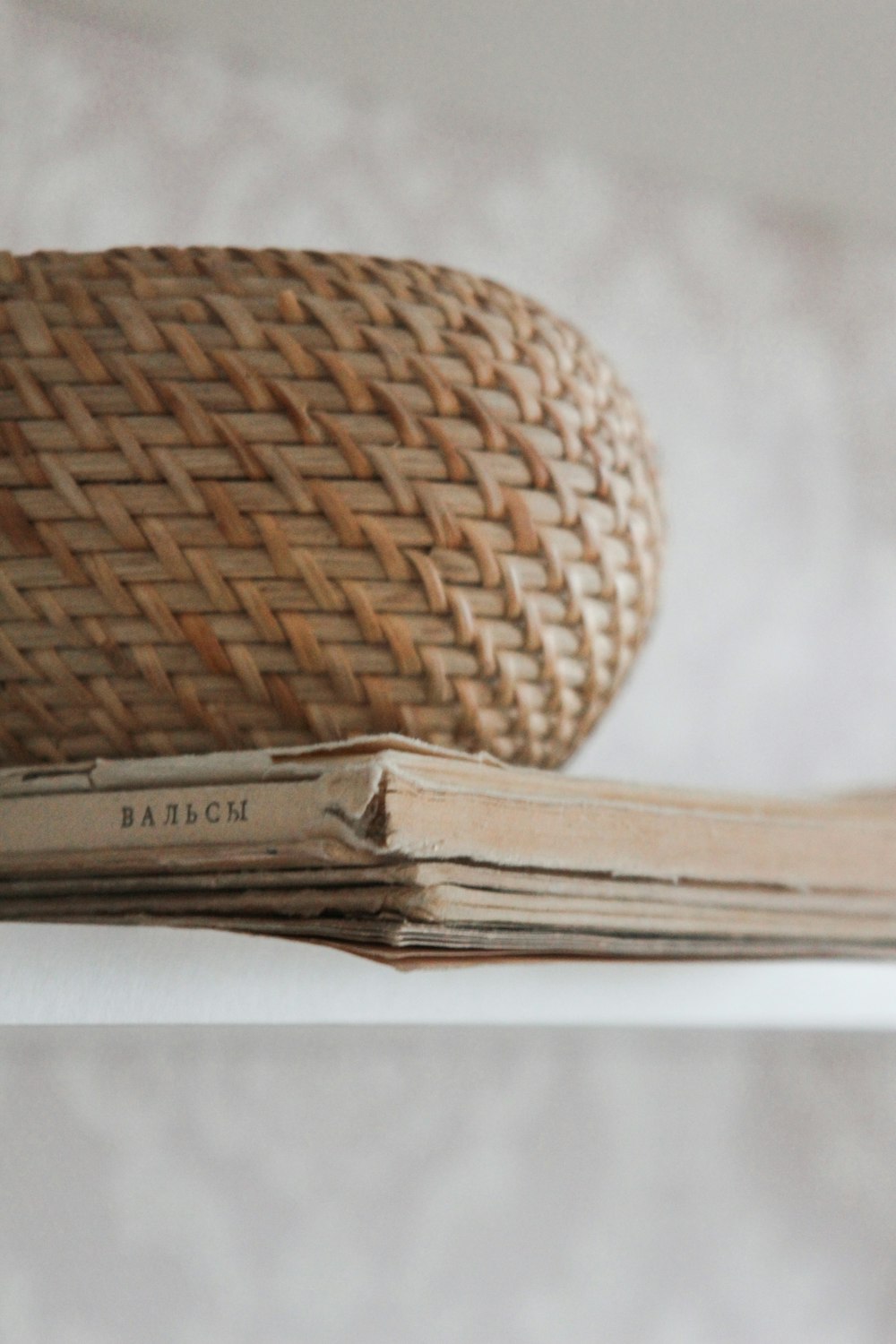 brown woven round basket on white table