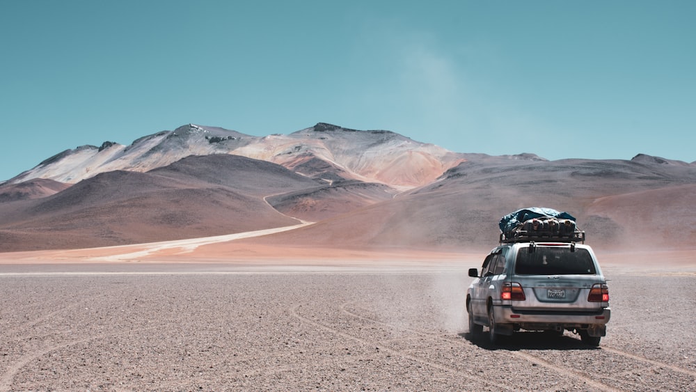 black suv on gray dirt road during daytime