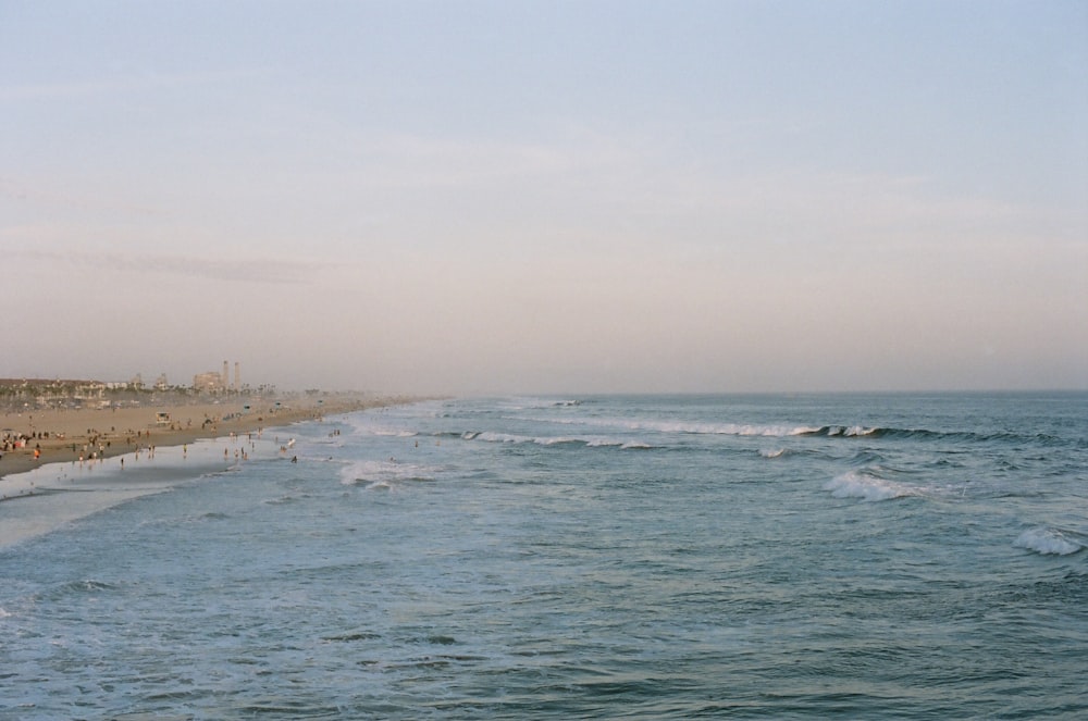 body of water under white sky during daytime