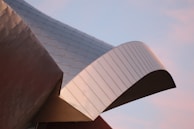 A panoramic view of a metal structure integrated into a modern building.