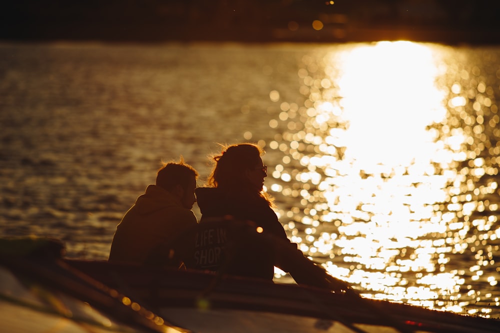 couple sitting on boat during sunset