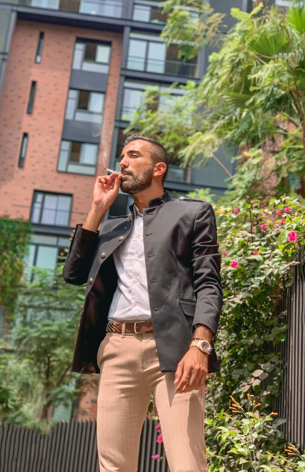 man in black suit jacket smoking cigarette