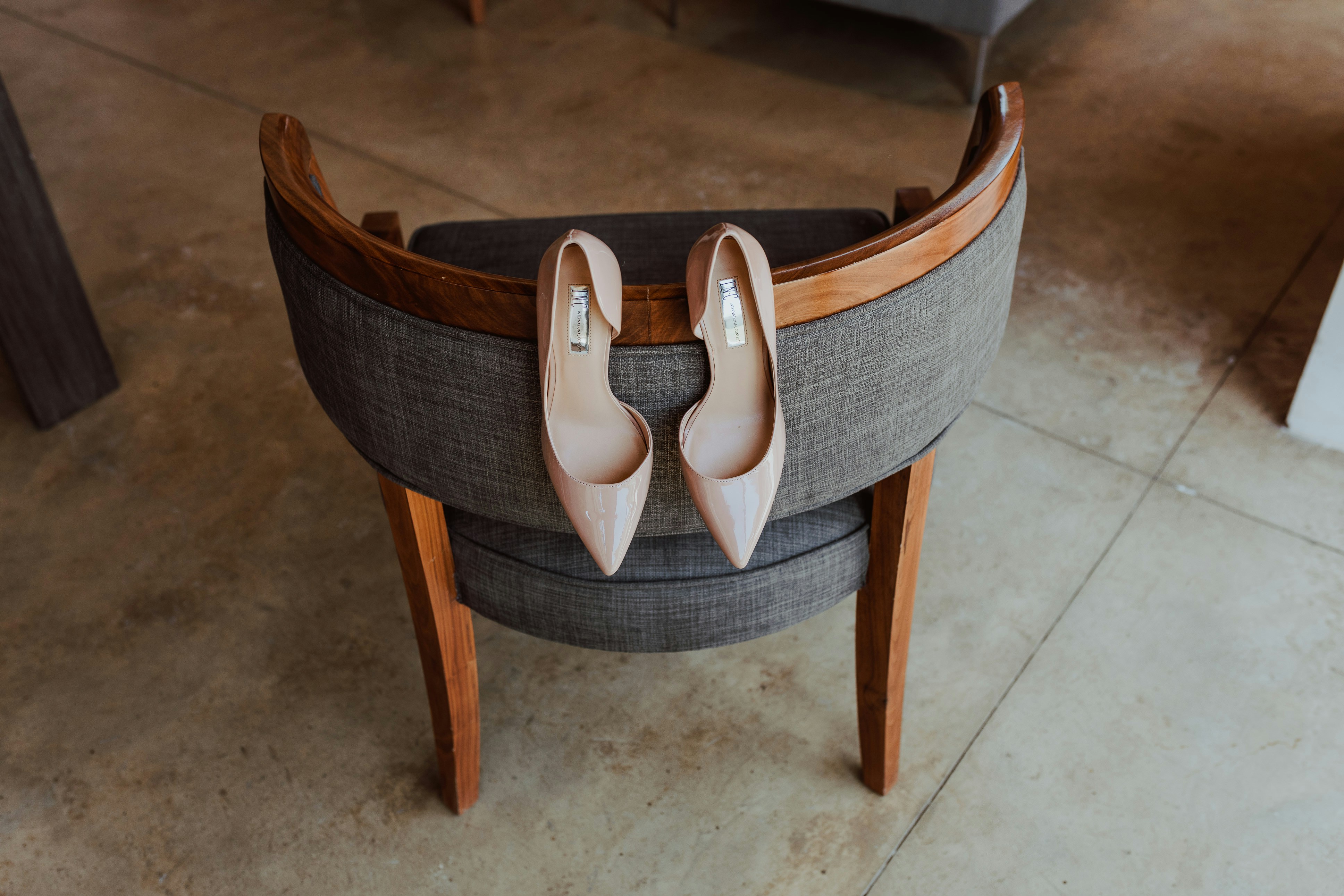 brown wooden framed gray padded armchair