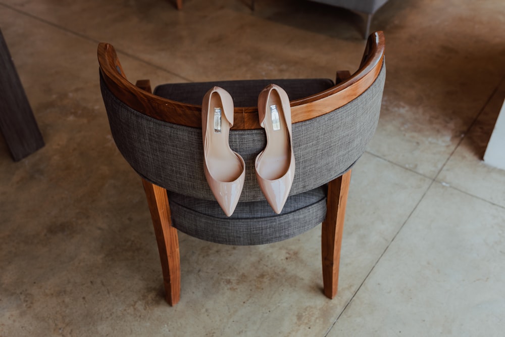 brown wooden framed gray padded armchair