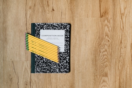 white and black card on brown wooden table