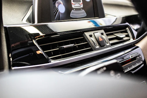 A sleek black and silver car dashboard with a glowing phone icon indicating contact.