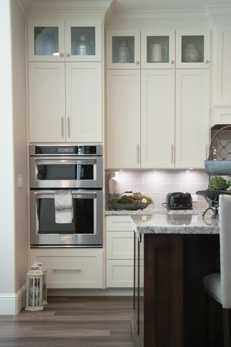 White kitchen cabinet and stainless steel microwave oven