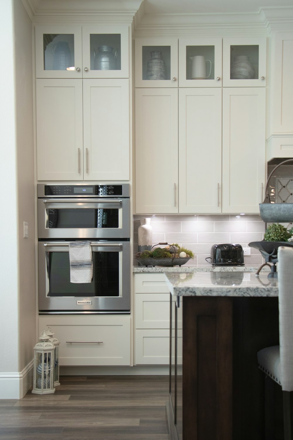 white wooden kitchen cabinet and stainless steel microwave oven