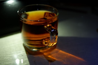 Warm, golden light illuminating a quiet moment of journaling beside a steaming cup of herbal tea.