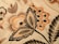 Intricate floral embroidery with detailed patterns in shades of orange, beige, and black. Large leaves and blooming flowers create a vintage and artistic appearance.