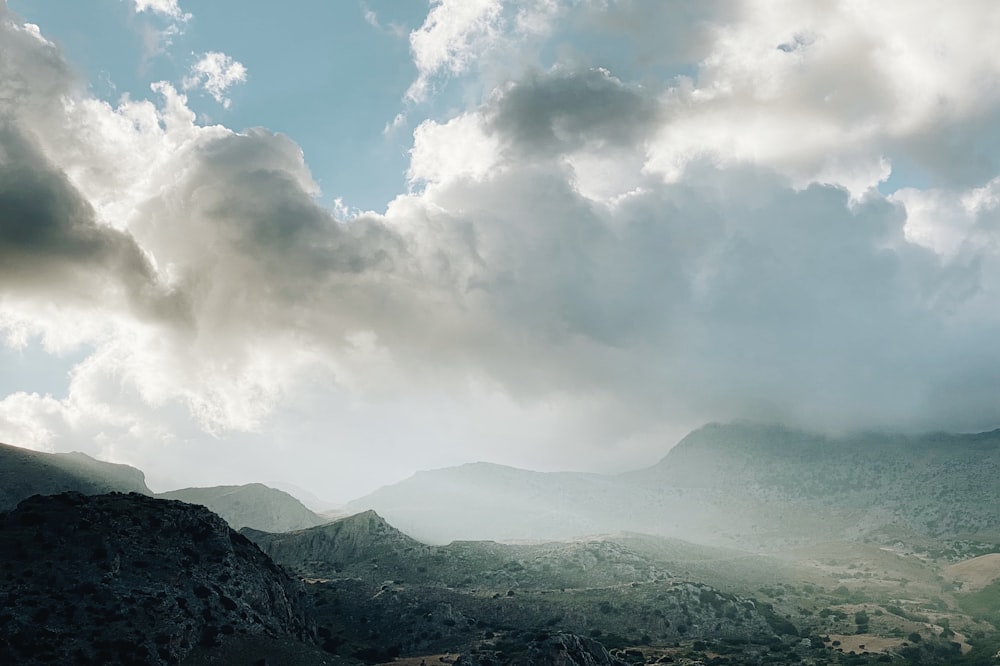 green mountains under white clouds during daytime