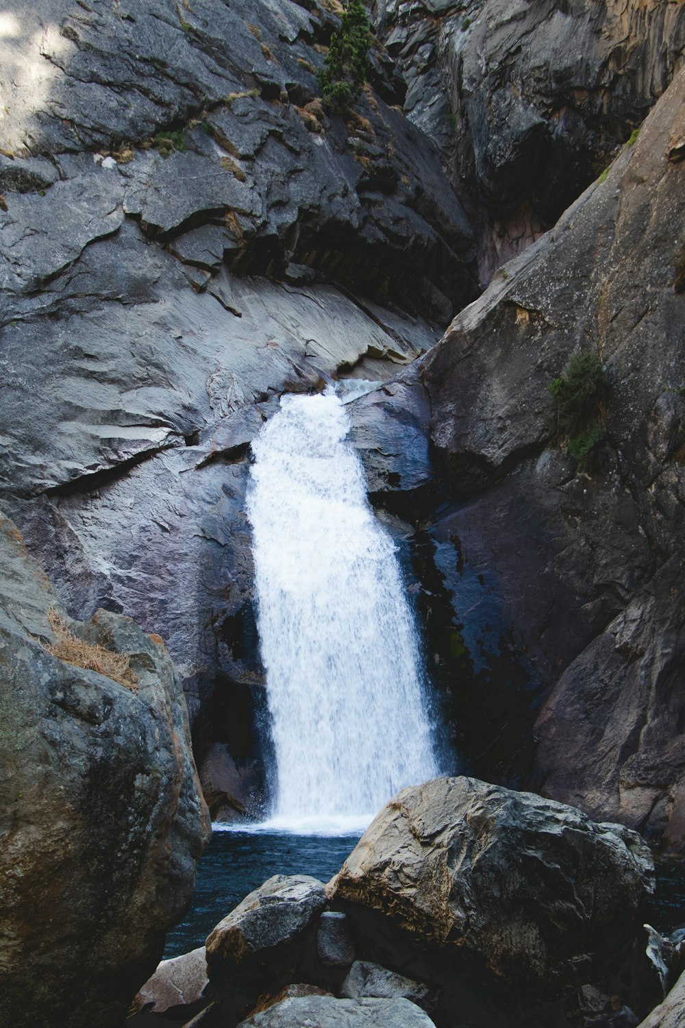 waterfalls on rocky mountain during daytime