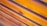 Smooth wooden planks arranged horizontally with visible grain and a warm, polished finish.