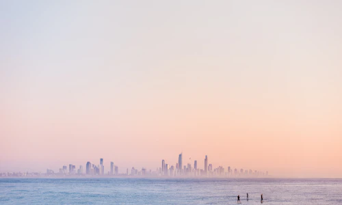People enjoying a sunny day on a busy Gold Coast beach