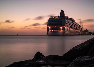 A warm, inviting photo of a cruise ship docked at Miami port during sunset.