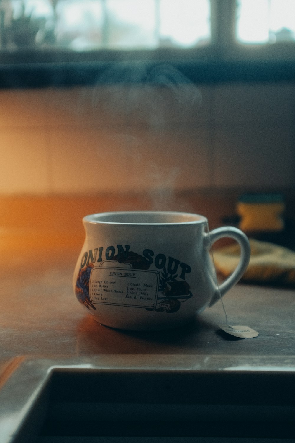 white and brown ceramic mug on brown wooden table