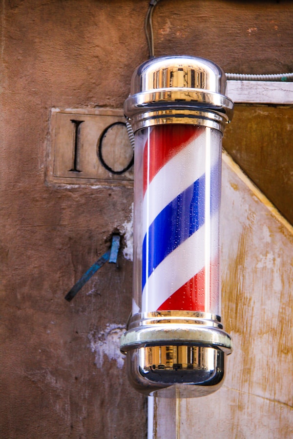 The iconic red, white and blue barber’s pole, outside a barbershop in Rome.by Nick Fewings