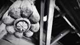 A rustic wooden craft piece with detailed carvings resting on a textured fabric.
