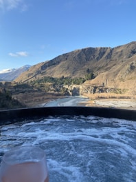 A serene ice bath setup with clear water and surrounding natural elements.
