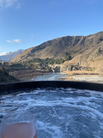A serene ice bath setup with clear water and surrounding natural elements.