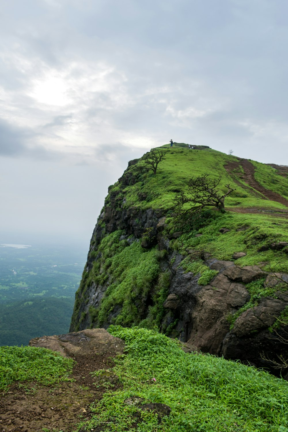 green and gray rock formation under white clouds during daytime