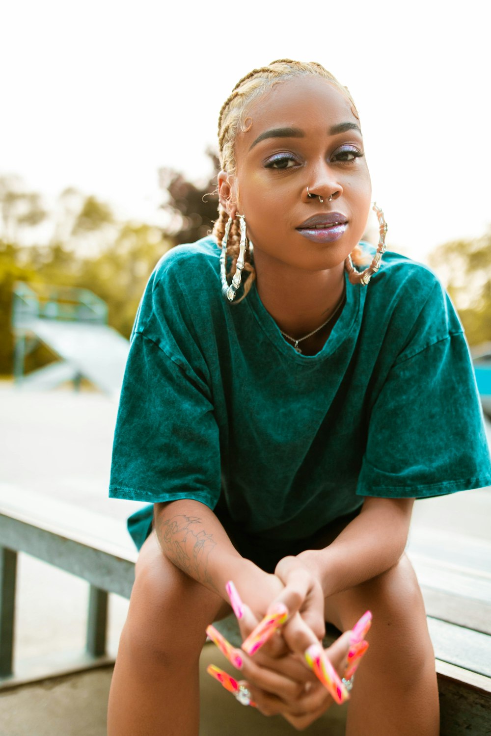 girl in green dress sitting on white wooden bench