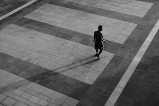 An outdoor scene showing a person navigating with a smart cane.