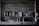 Several fire extinguishers are mounted on a weathered, industrial wall with various signs and papers attached above. The setting is dimly lit, giving it a slightly rustic and aged appearance. The lower part of the image shows more fire extinguishers placed on a countertop with visible wear.