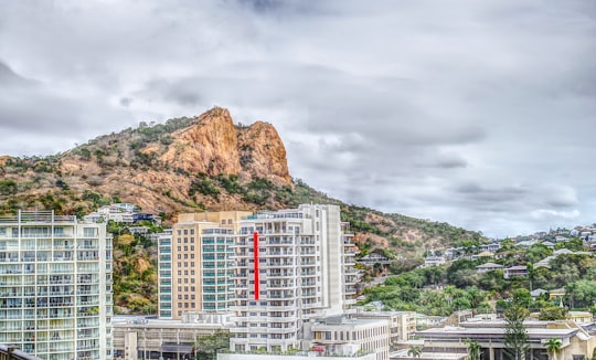 white and red concrete building near mountain under cloudy sky during daytime in Castle Hill Australia