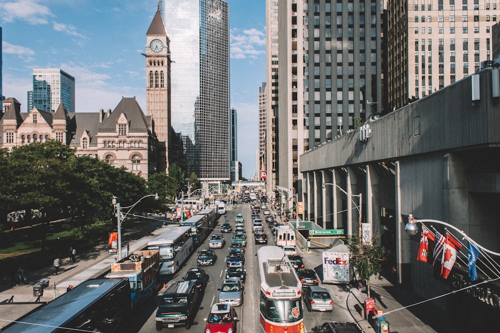 a city street filled with lots of traffic and tall buildings