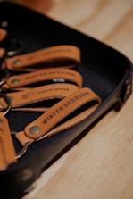 A set of leather accessories each with custom engraved designs.
