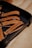 A set of leather keychains on a tray with the text 'Winter Session' and 'Made in Denver' embossed on them.