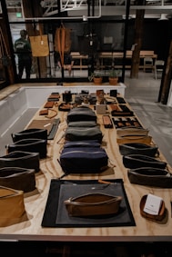 black and brown leather bag on brown wooden table