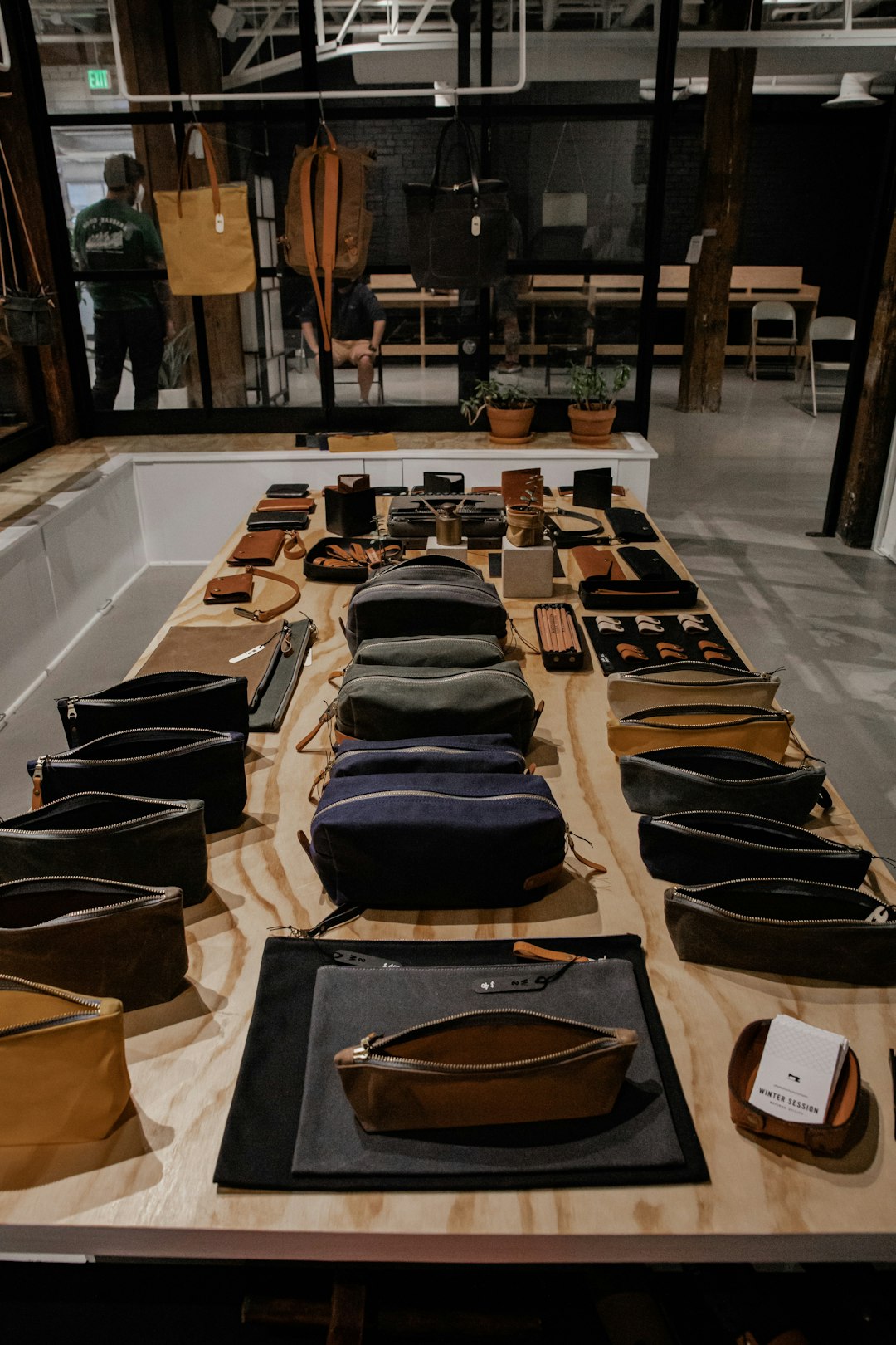 black and brown leather bag on brown wooden table