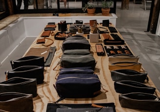 black and brown leather bag on brown wooden table