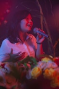 woman in white shirt singing