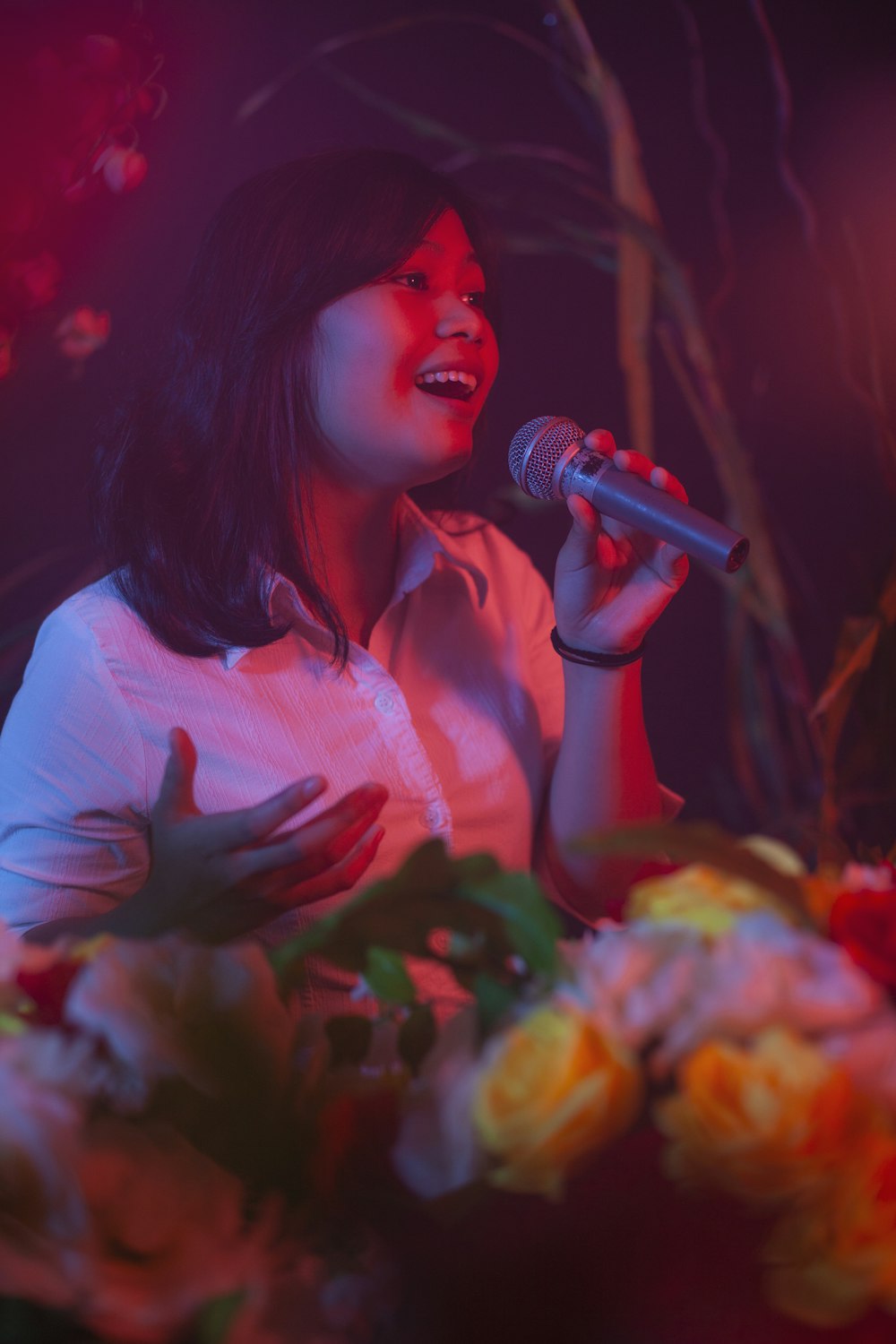 woman in white shirt singing