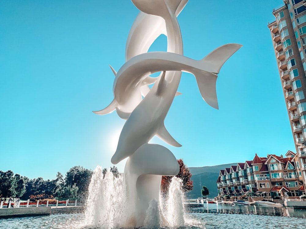 white concrete statue near body of water during daytime