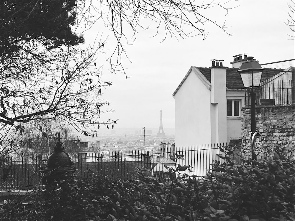 grayscale photo of house near trees