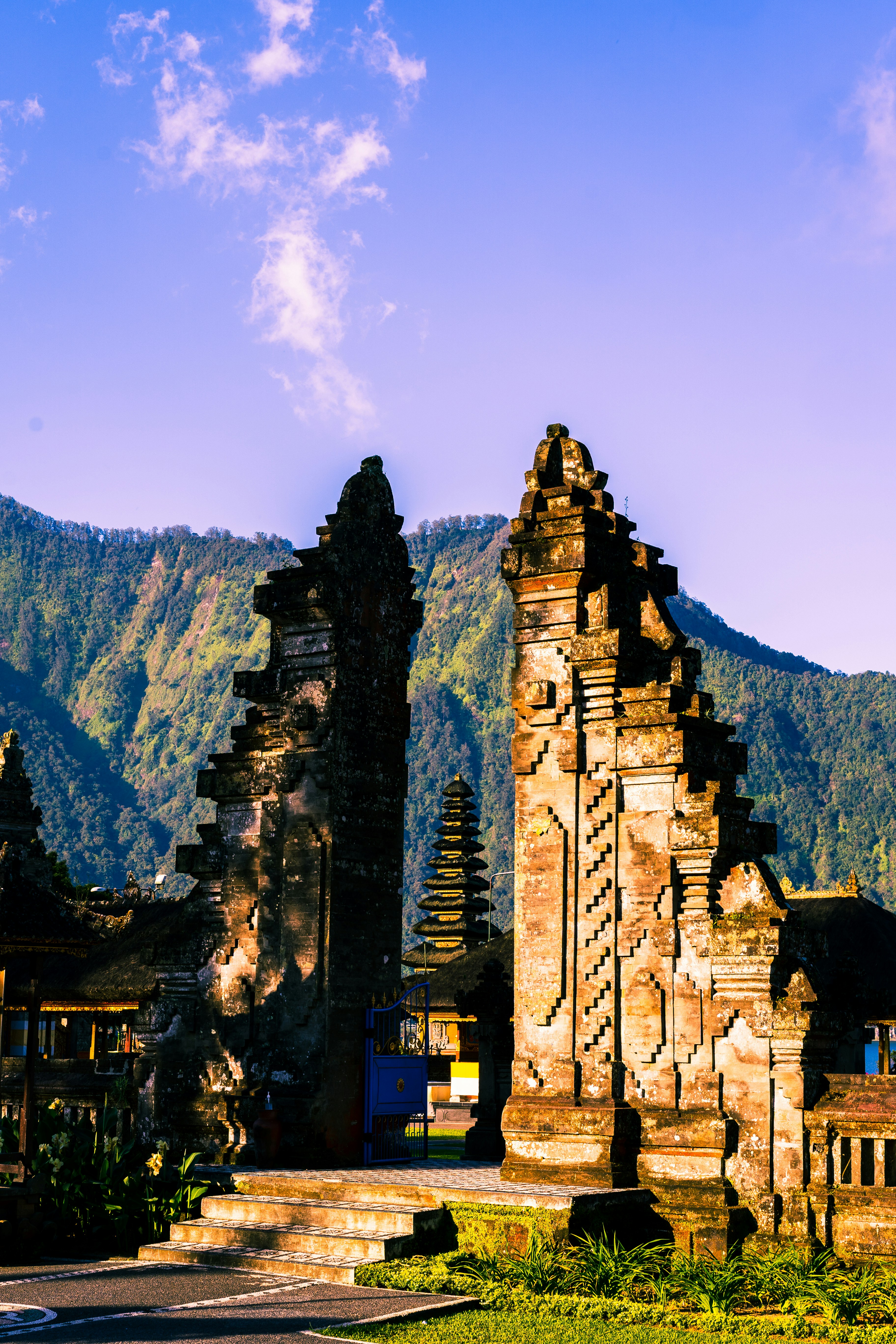 brown concrete building near mountain under blue sky during daytime