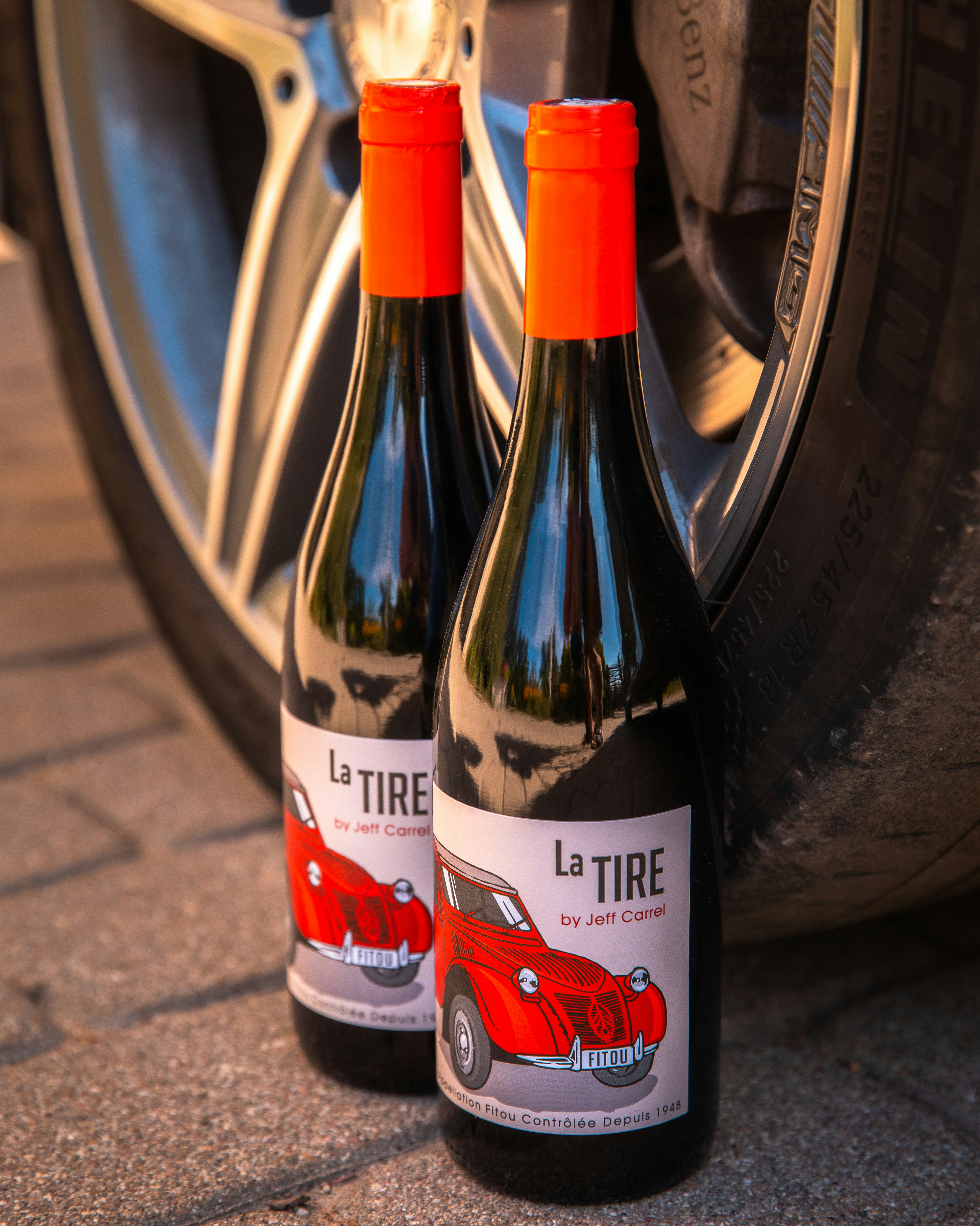 black glass bottle on gray concrete floor