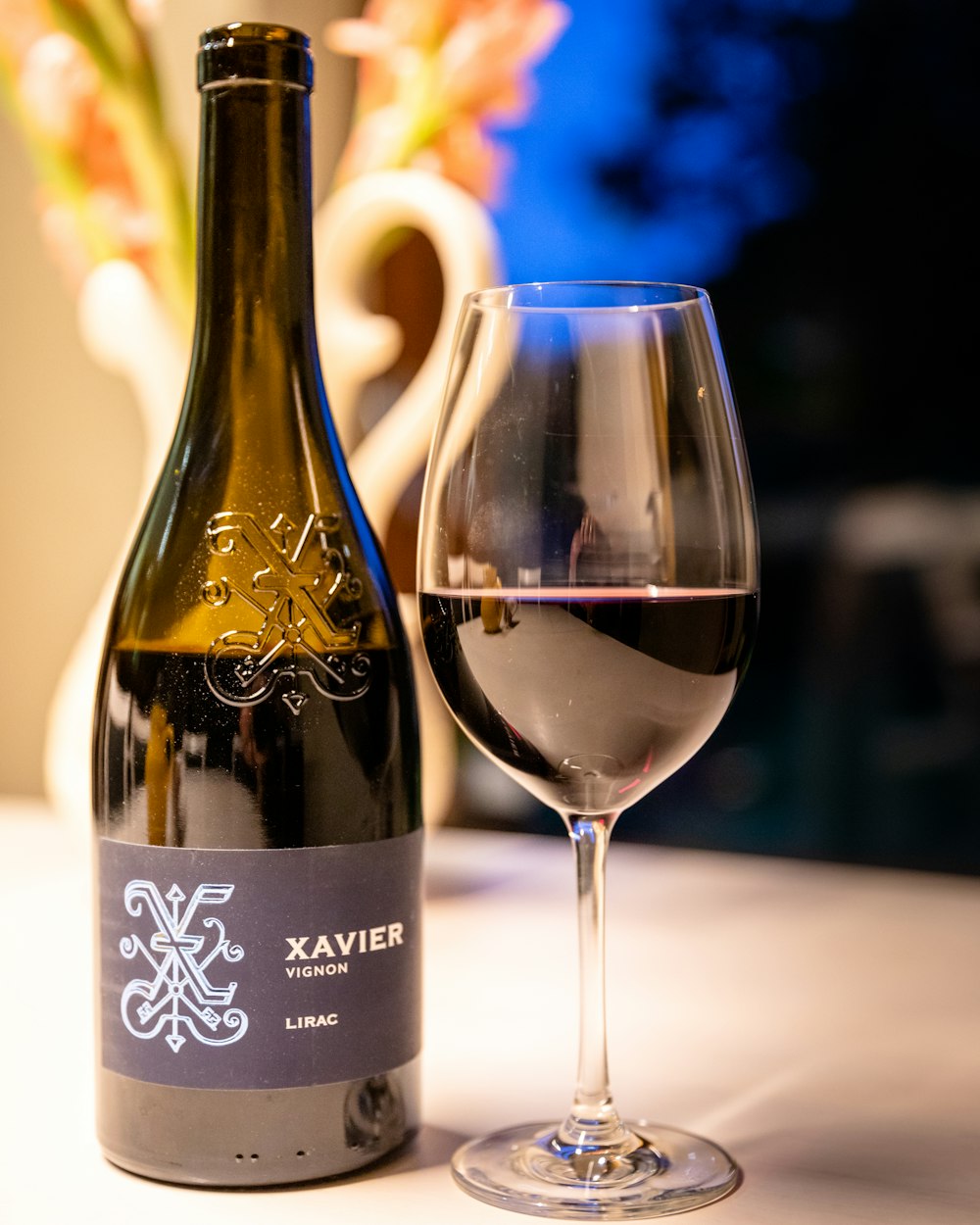 black glass bottle beside clear wine glass