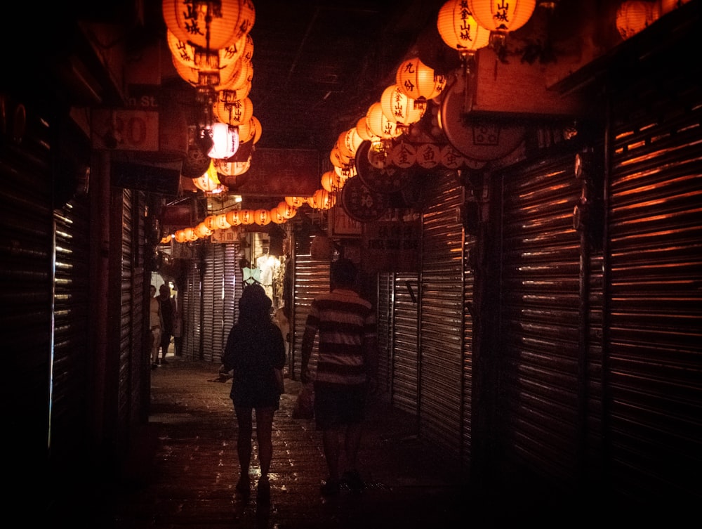 people walking on street during night time