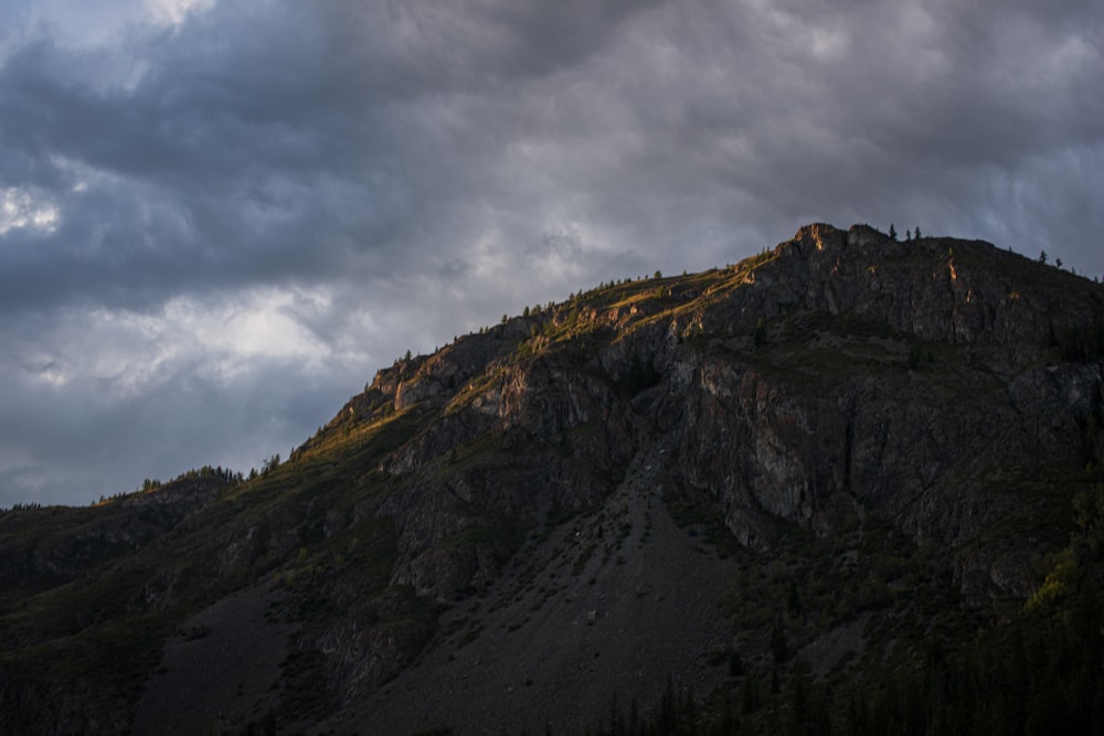 green and brown mountain under cloudy sky during daytime