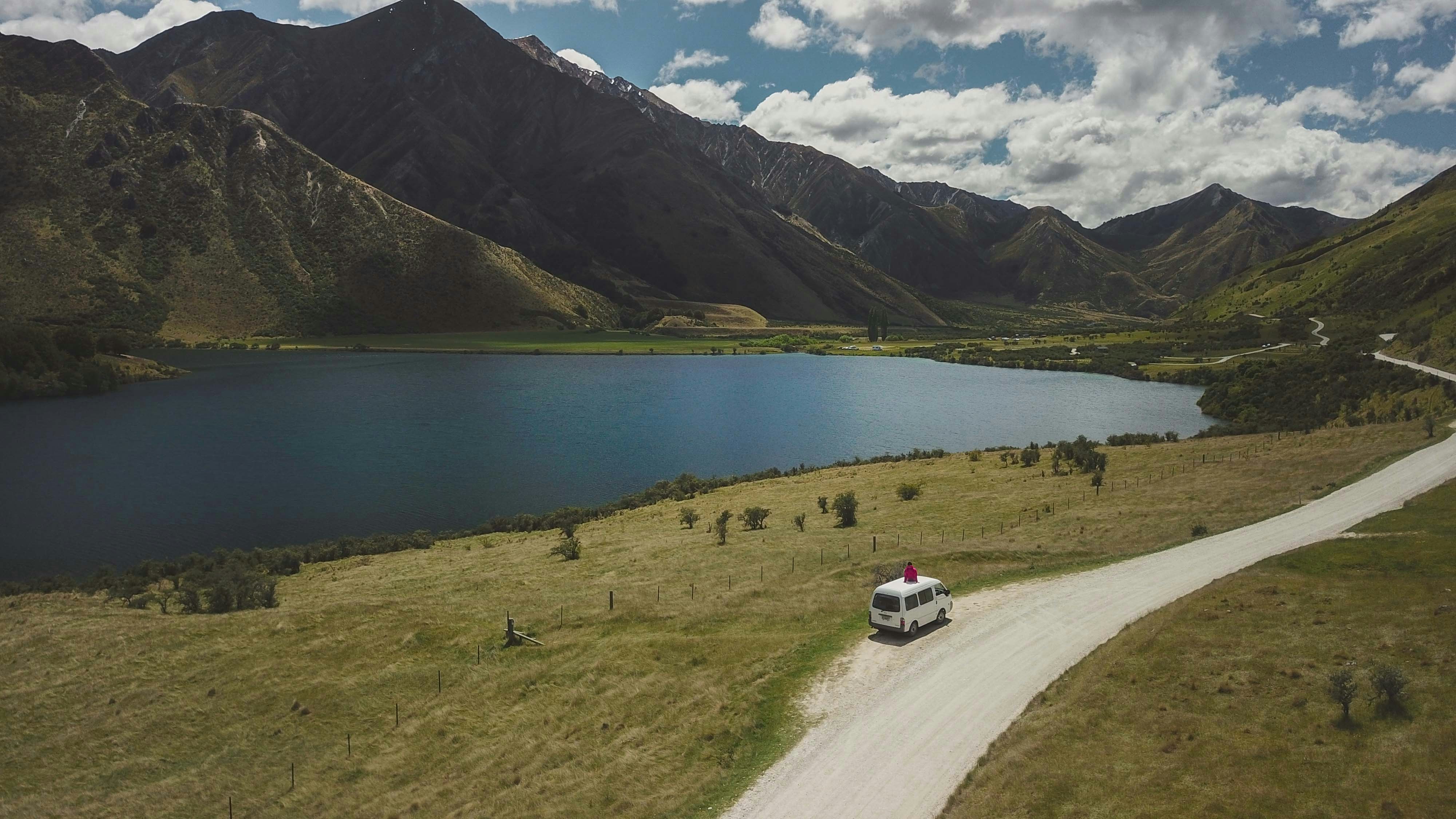 white car on road near lake during daytime, Some shots taken during our travels across New Zealand, our country of heart. More photos and inspiring stories on Instagram > @Aboutmaps ;-)