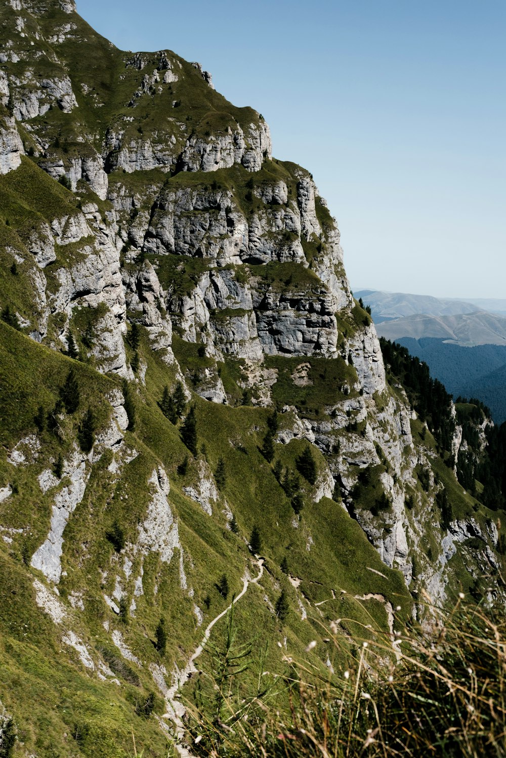 green and gray rock mountain under blue sky during daytime