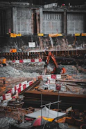 Heavy-duty machinery operating on a construction site with workers in safety gear