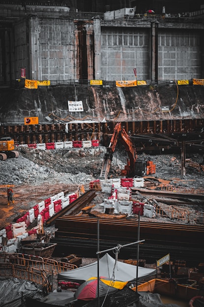 Construction workers operating heavy machinery on a building site in Leipzig.