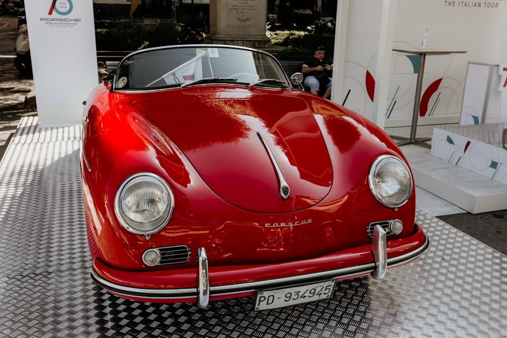 red porsche 911 parked in front of white building