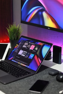 black laptop computer turned on beside silver imac